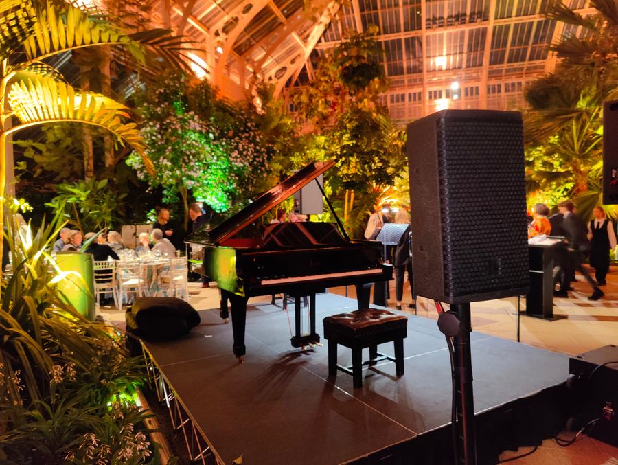 Grand piano and PA at a corporate glasshouse event